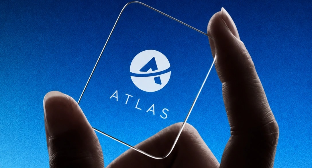 Hand holding a glass card with the Atlas mark
